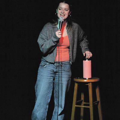A comedian performing on the Club Voltaire stage