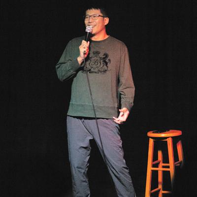 A comedian performing on the Club Voltaire stage