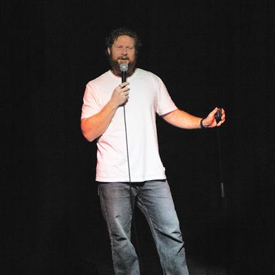 A comedian performing on the Club Voltaire stage