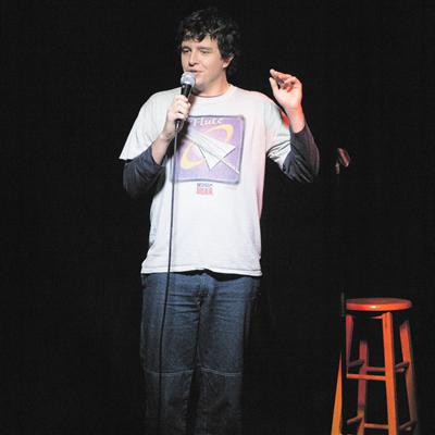 A comedian performing on the Club Voltaire stage