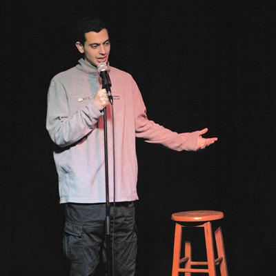 A comedian performing on the Club Voltaire stage
