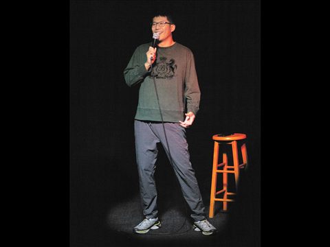 A comedian performing on the Club Voltaire stage