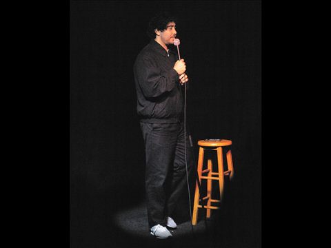 A comedian performing on the Club Voltaire stage