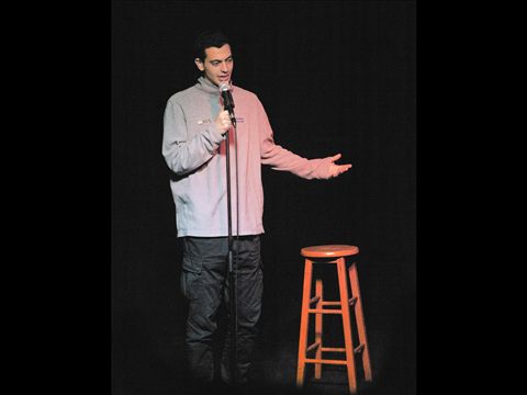 A comedian performing on the Club Voltaire stage